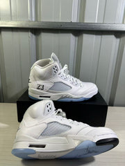 Pair of white and silver high-top sneakers shown from the side on a black shoe box.