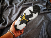 View of the outsole showing black and translucent sections with a gold Jumpman logo.