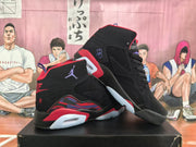 Angled view of the pair of black high-top sneakers highlighting the perforated side panels and layered red and purple midsole accents.