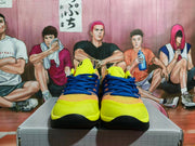 Front view of yellow and blue Nike Kobe basketball shoes