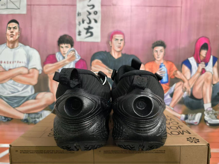 Rear view of a pair of all-black Nike basketball sneakers on a box.