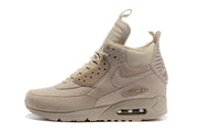Side profile of a light beige Nike Air Max 90 Winter sneakerboot with visible Air units.