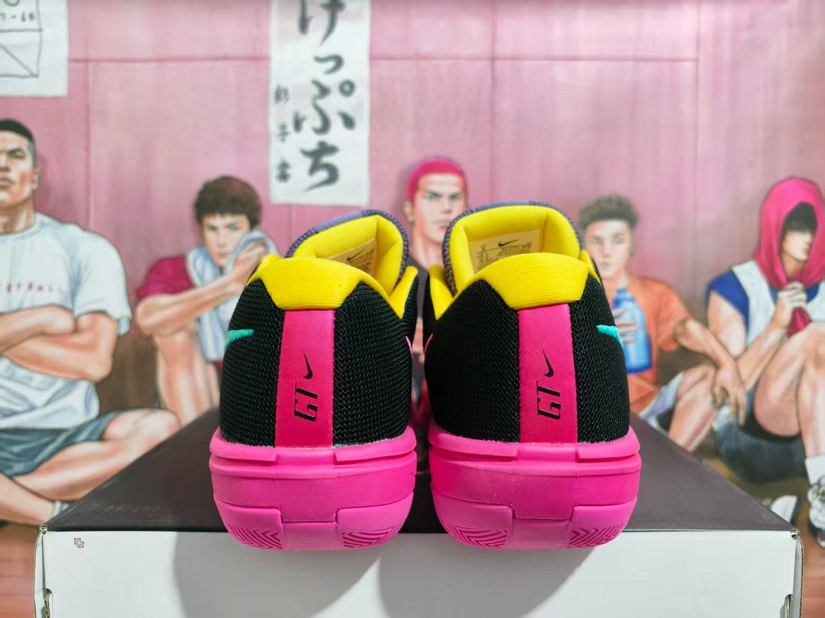 Rear view of pink and black Nike GT Cut basketball shoes with yellow collars and pink heels.