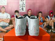 Rear view of the pair showing gray heel panels, black collar trim, and visible orange NIKE WRESTLING text.