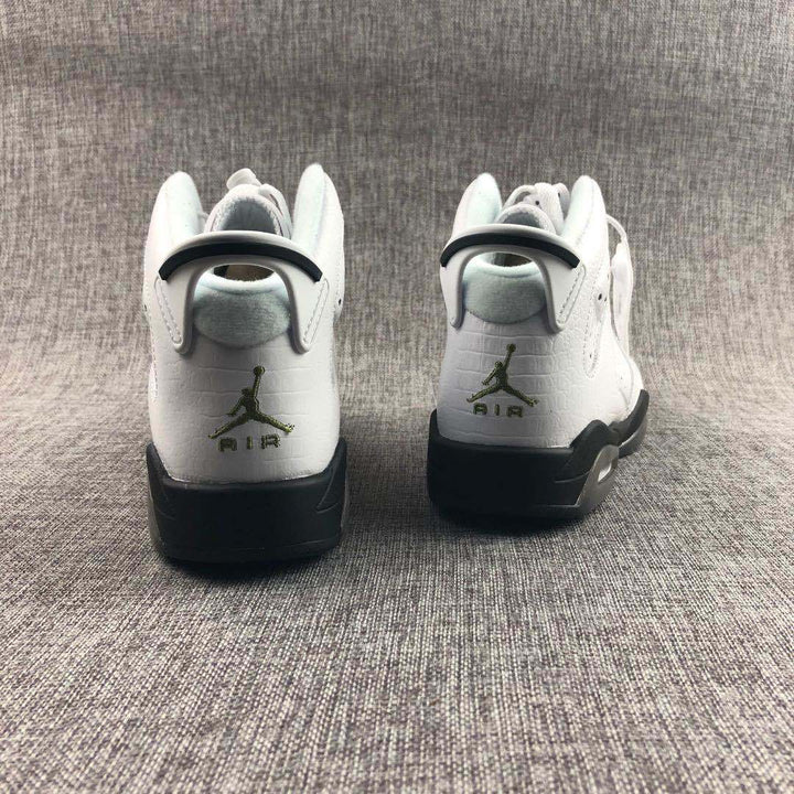 Rear view of the white and black Jordan Air Jordan 6 sneakers showing heel branding and textured uppers.