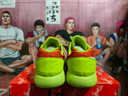 Rear view of a pair of bright yellow Nike sneakers showing the padded collars, heel panels, and embossed Nike branding.