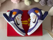 Overhead view of the sneakers placed on a red shoebox.