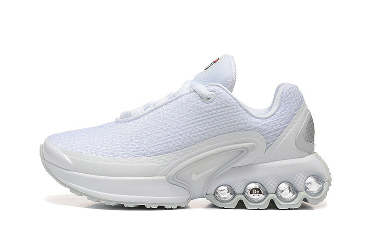 Side view of a white Nike sneaker with a textured upper and multi-column heel cushioning.