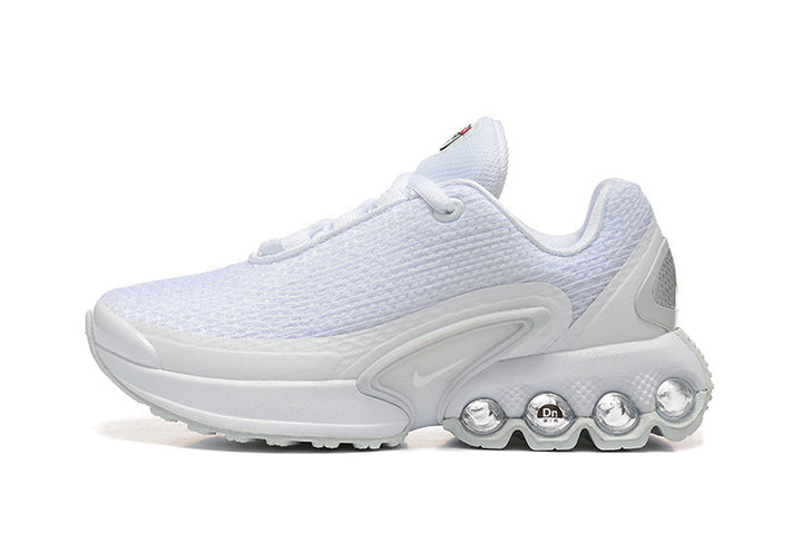 Side view of a white Nike sneaker with a textured upper and multi-column heel cushioning.