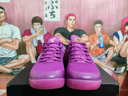 Front view of purple Nike basketball sneakers with matching laces, textured uppers and translucent-looking purple outsoles.