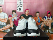Front view of white and black Nike sneakers showing perforated toe panels and laces.