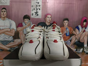 Front view showing the white toe boxes, perforations, laces, and red lace accents.
