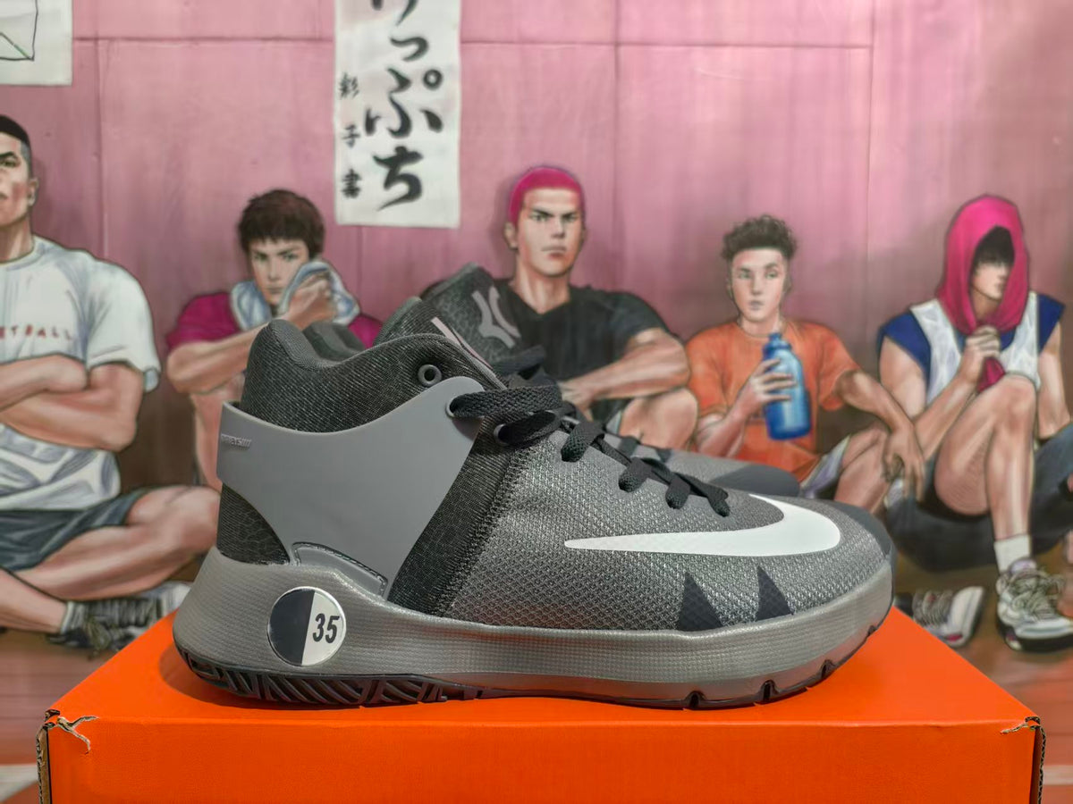 Side view of a grey and black Nike KD basketball shoe with white Swoosh detail and an EU 35 sample marking