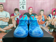 Front view of the pair showing blue laces, textured blue uppers, and red Kobe-style tongue graphics.