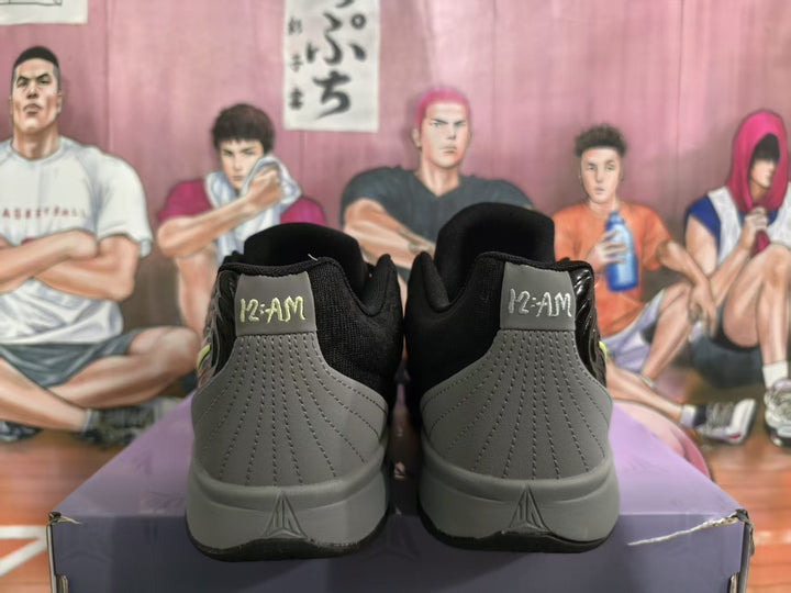 Rear view of black and gray sneakers showing gray stitched heel panels, black collars, and heel branding.
