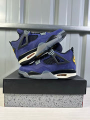 Pair of purple Jordan Air Jordan 4 sneakers arranged on a black shoebox in a side view.