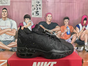 Side profile of a black Nike sneaker showing layered panels, side branding, and a sculpted outsole.