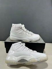 White high-top sneakers photographed from the side, showing tonal overlays, laces, and translucent outsole sections.
