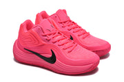 Pair of pink Nike basketball sneakers shown at a three-quarter angle with lace-up fronts and textured uppers.