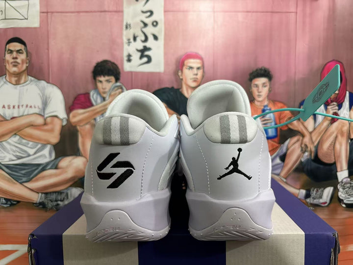 Rear view of white and grey Jordan basketball sneakers showing contrasting tongue and heel logos.