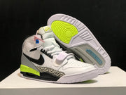 Three-quarter view with one sneaker lifted to reveal the white and neon yellow outsole pattern.