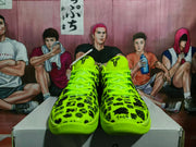 Front view of the paired sneakers showing green laces, black graphic print, and Kobe-style tongue logos.