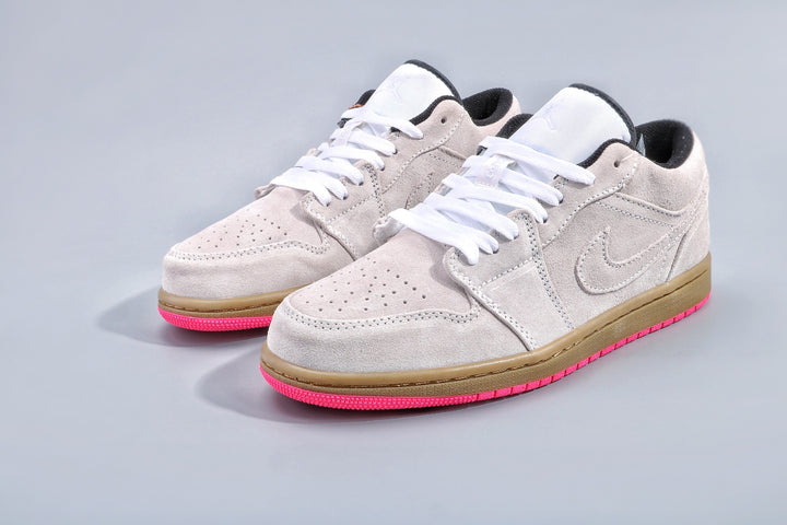 Pair of light gray low-top sneakers with white laces, gum-colored midsoles, and bright pink outsoles.