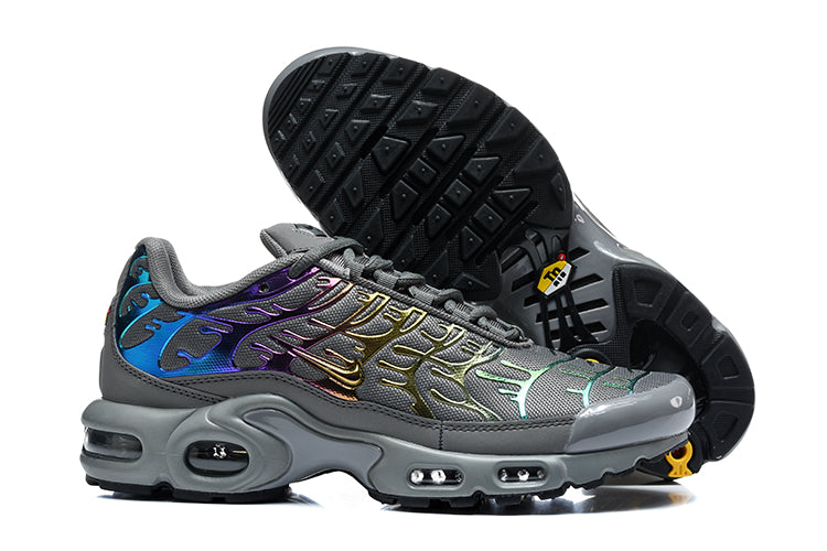 Nike Air Max Plus sneakers showing the outsole and side profile in dark grey with iridescent accents