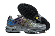 Nike Air Max Plus sneakers showing the outsole and side profile in dark grey with iridescent accents