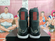 Rear view showing black knit collars, red vertical heel accents, dark patterned heel panels, and white outsoles.