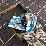 Pair of blue and white high-top sneakers shown inside an open box with printed wrapping paper.