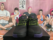 Front view of the pair showing black textured toe panels, bright yellow-green laces, purple outsoles, and Kobe tongue emblems.