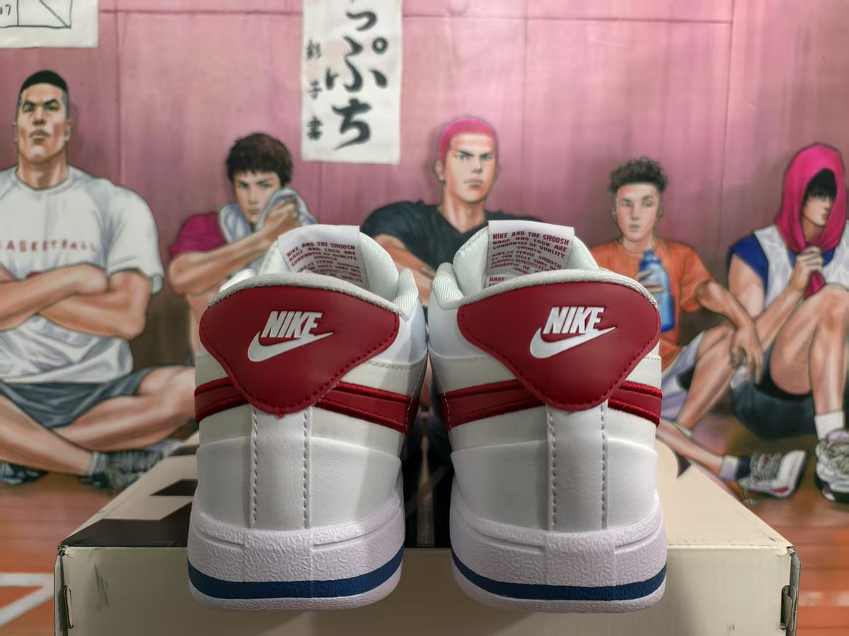 Rear view of white Nike low-top sneakers with red heel panels and a blue outsole stripe.