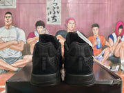 Rear view of the black Nike sneakers showing padded heel sections and textured upper panels.