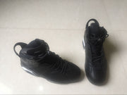 Top and side view of two black high-top sneakers showing heel pull tabs and perforated panels.