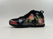 Black high-top sneaker decorated with multicolor floral graphics.