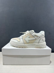 Side profile of a cream-white low-top sneaker with layered upper panels and a thick rubber sole.
