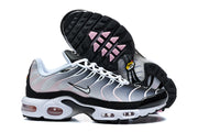 Nike Air Max Plus sneakers showing the side profile and black outsole with pale pink accents