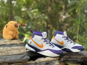 Pair of high-top basketball shoes photographed from the side with white uppers and purple-orange accents.