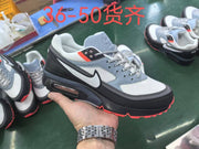 Nike-branded sneaker held in a hand, showing gray, black and white panels, coral accents and a visible heel air unit; overlaid text lists sizes 36–50.