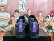 Rear view of purple and black Nike Kobe basketball shoes
