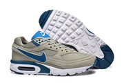 Gray and blue Nike Air Max sneakers shown with the patterned outsole.