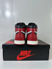 Rear view of the pair showing red heel panels, black collars, and white midsole sections.