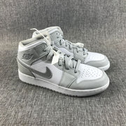 Three-quarter view of the pair showing the laces, perforated toe boxes and layered upper panels.