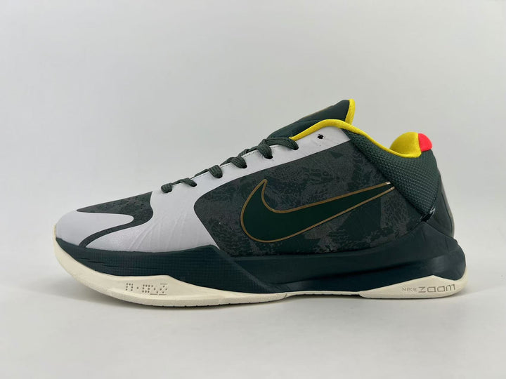 Side view of a dark green and gray Nike low-top sneaker with yellow accents and an off-white outsole