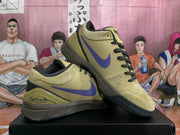 Angled view of the olive and purple basketball sneakers displayed one over the other.