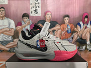 Side view of a grey Nike LeBron basketball shoe with black and bright pink accents.