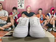 Front view of white lace-up Nike basketball sneakers with perforated toe panels