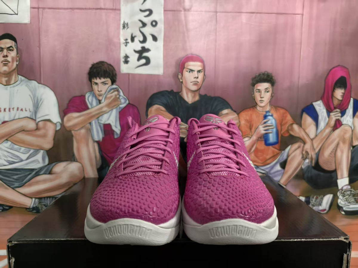 Front view of pink Nike Zoom basketball sneakers with textured uppers, white midsoles, and pink accents, displayed against an illustrated basketball backdrop.