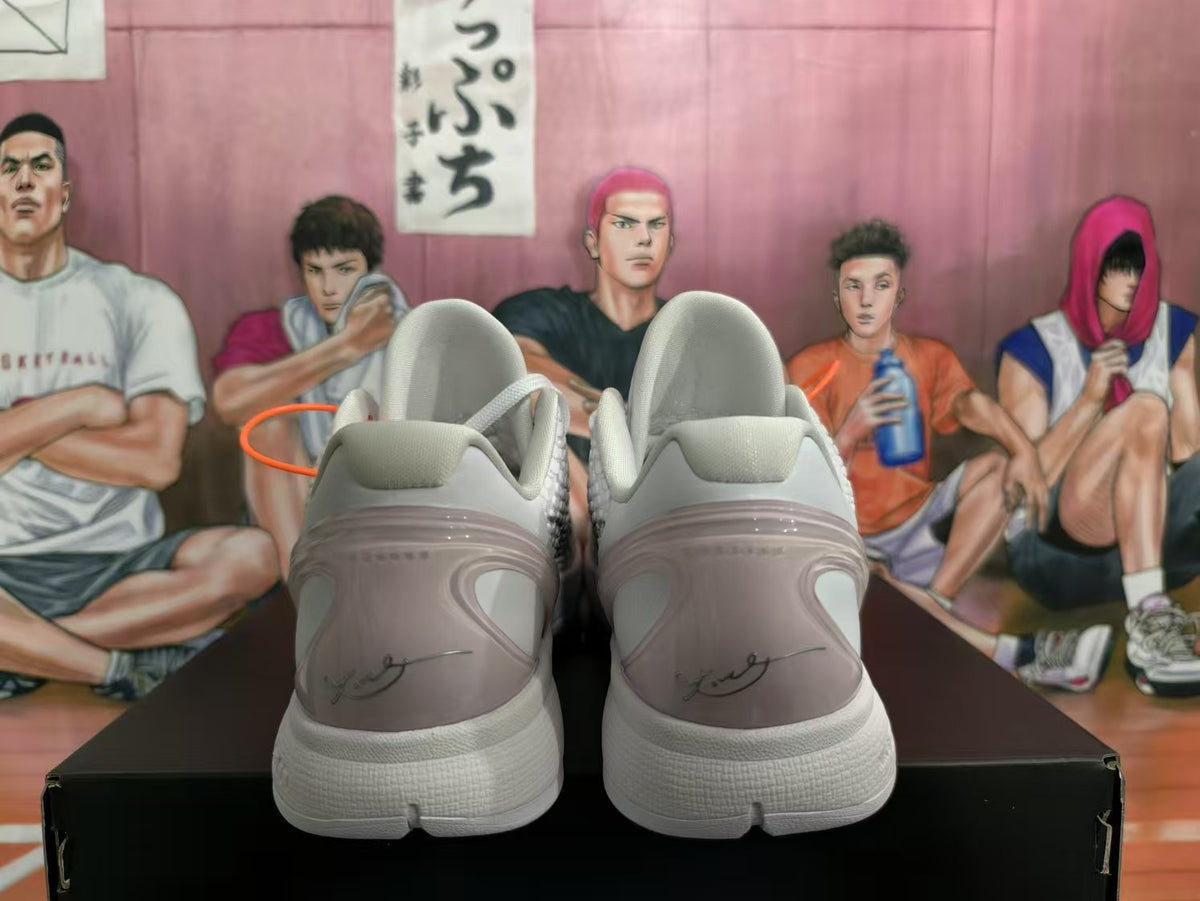 Rear view of white and silver Nike basketball sneakers showing padded heels, translucent heel panels, and Kobe signature details.